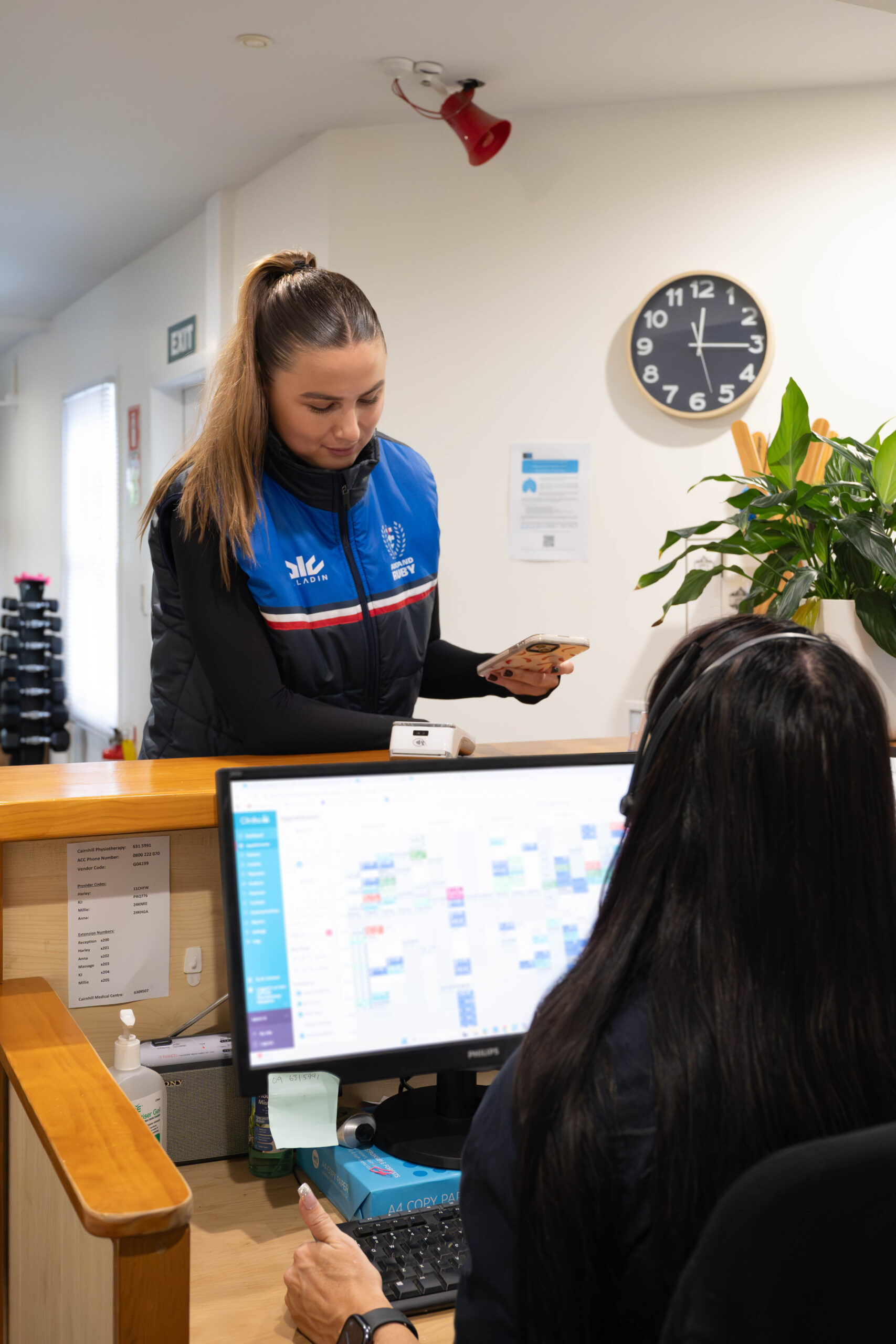 A patient booking at the Cairnhill Physiotherapy reception desk