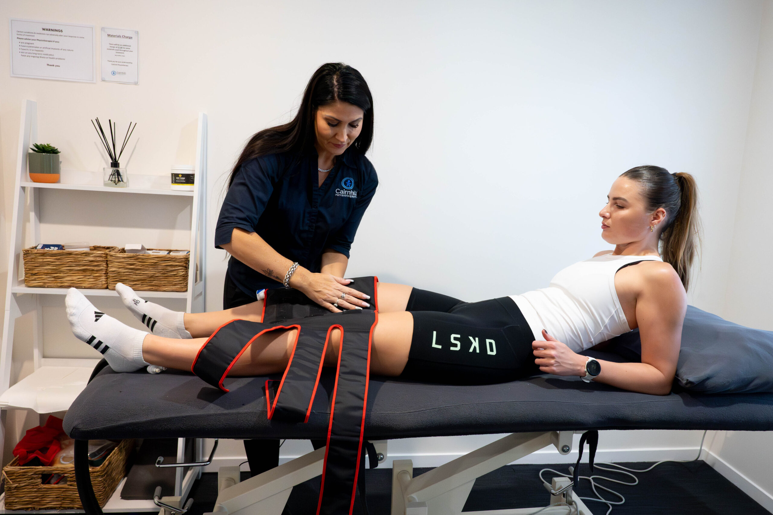 A physiotherapist setting up the cold compression system for a patient in the clinic