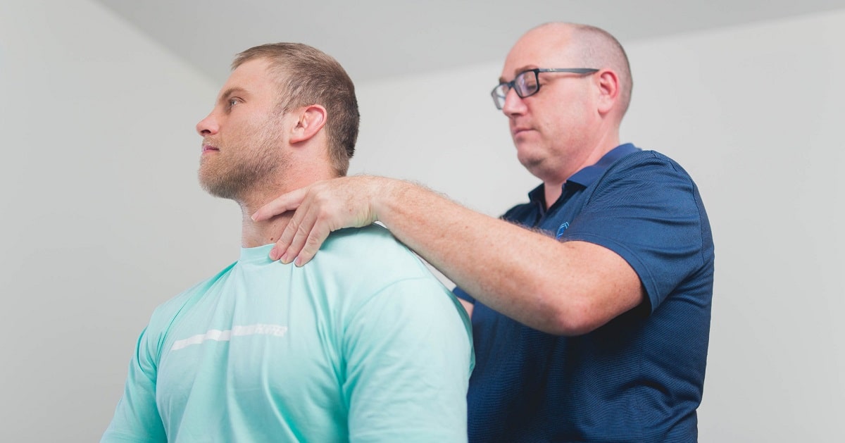 A physiotherapist treating a work-related neck injury