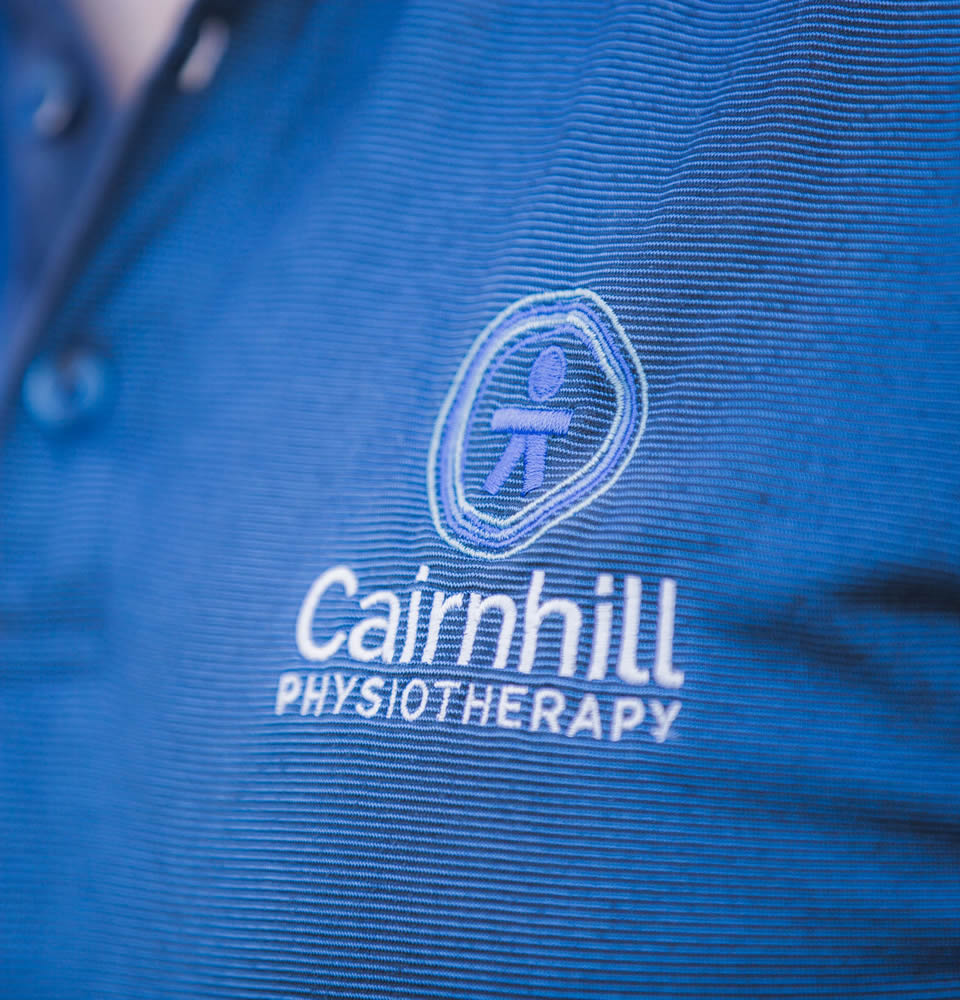 The Cairnhill Physiotherapy logo embroidered on a clinic polo shirt