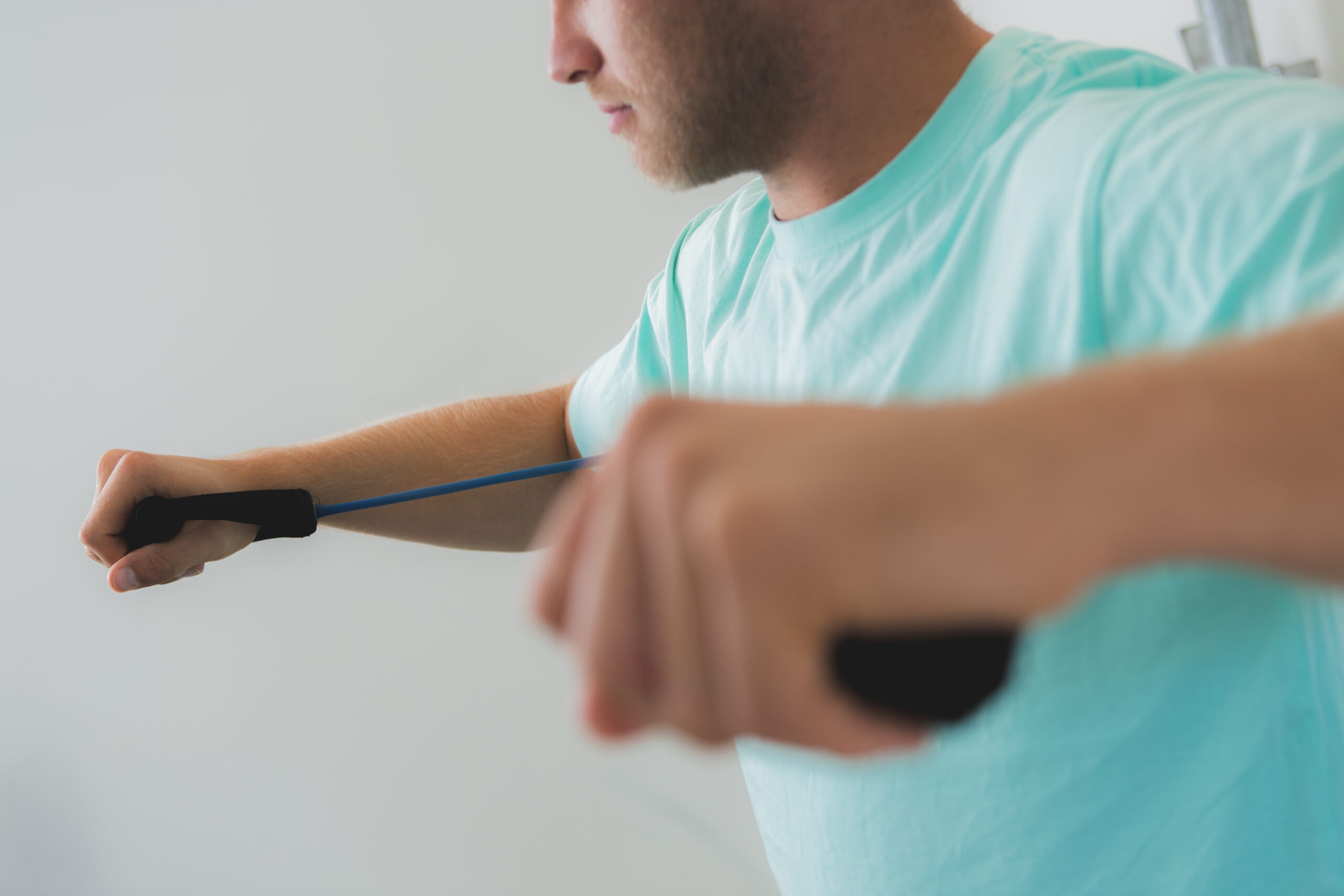 A patient working through a shoulder exercise with a resistance band
