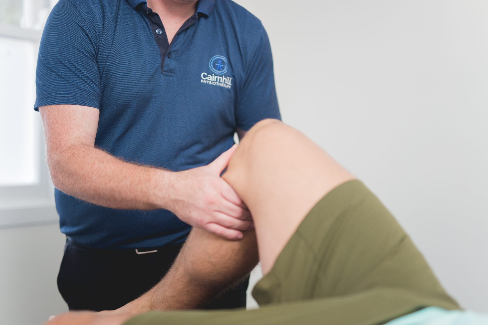 A physiotherapist assessing a patient’s knee