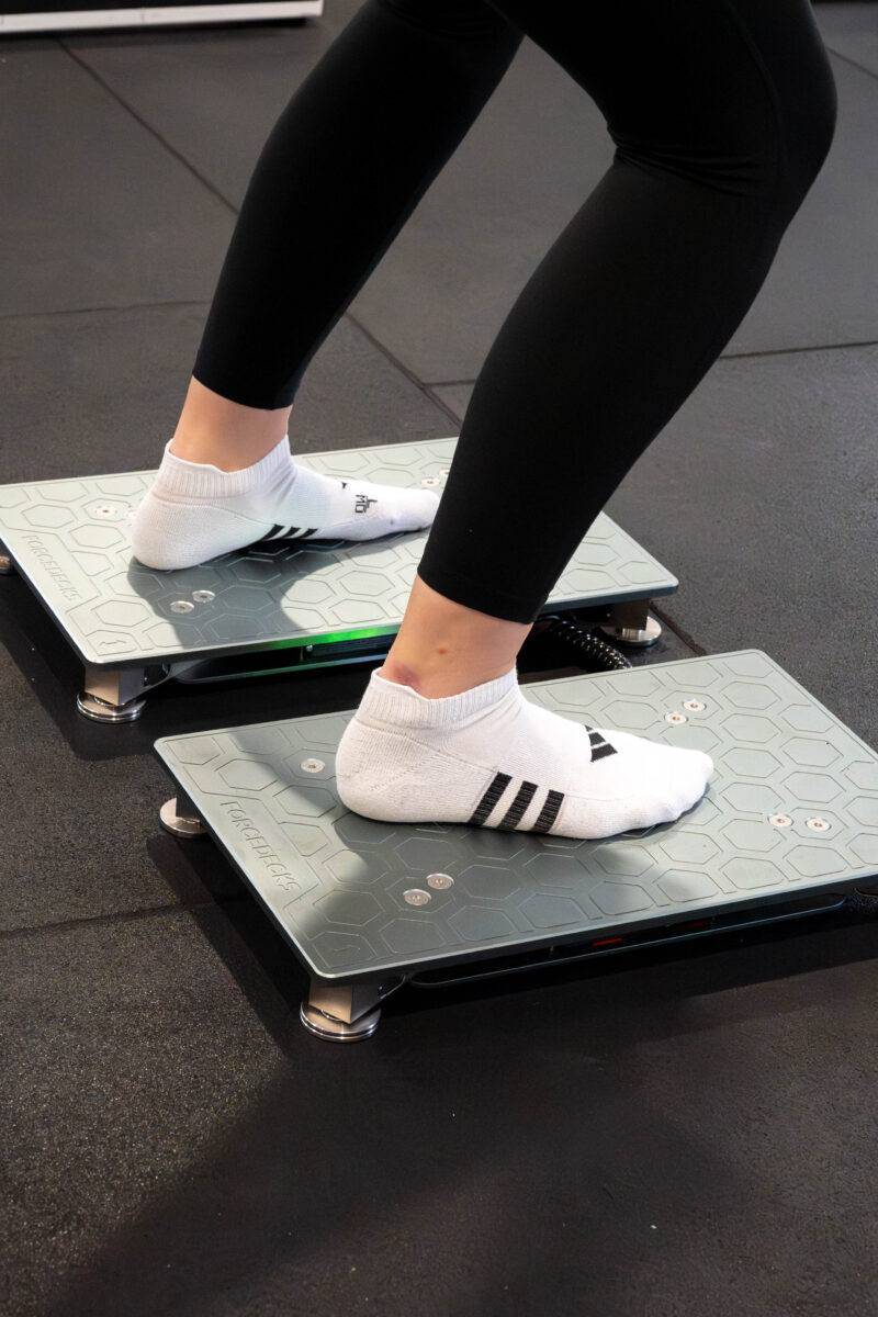 A patient standing on force plates during testing