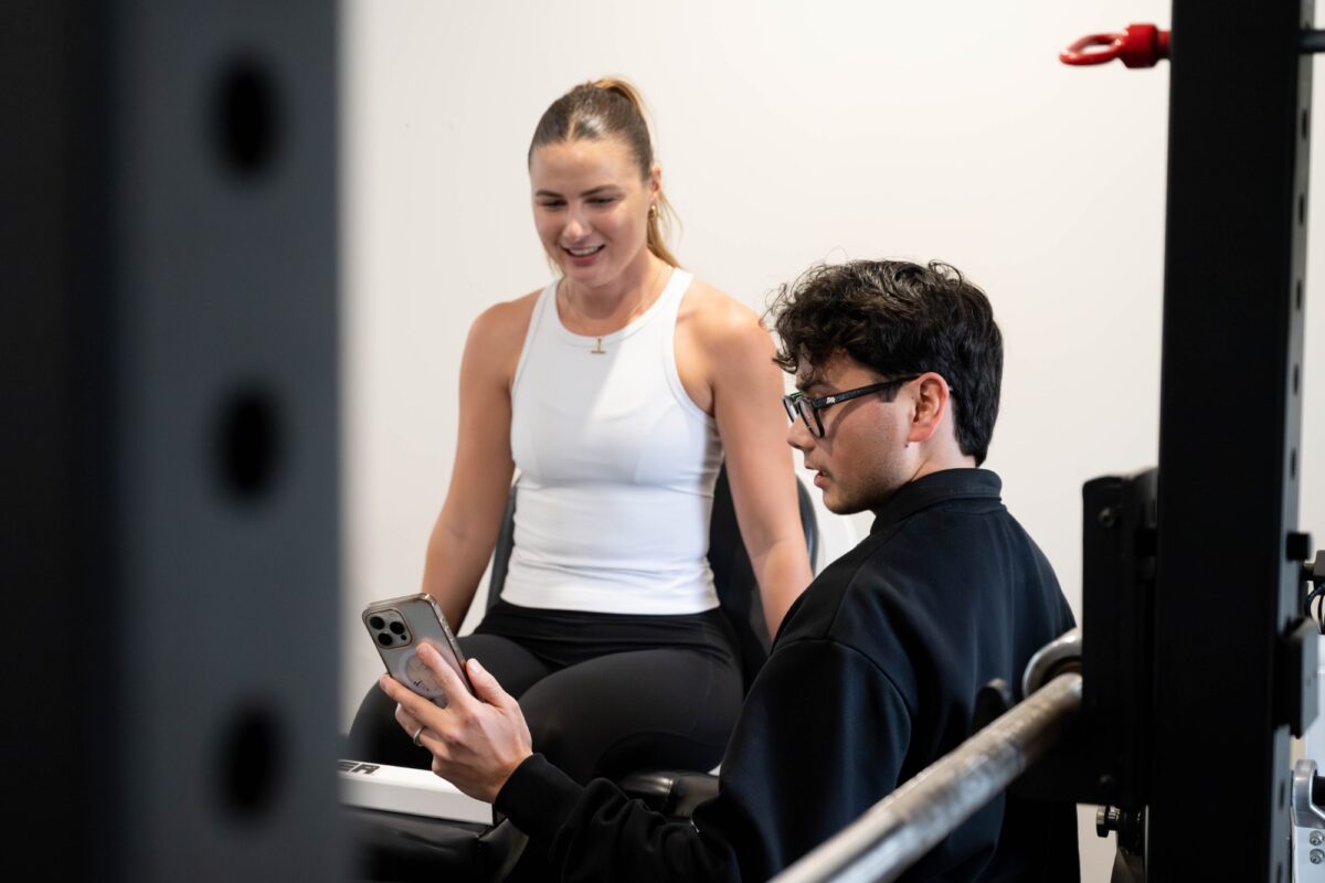 A physiotherapist going through a patient's exercise programme with her in the rehabilitation gym